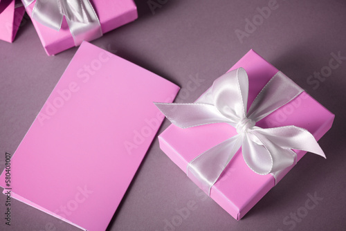 Pink gift boxes with a white ribbon