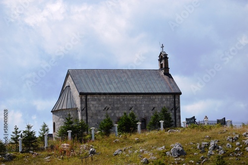 Fototapeta Naklejka Na Ścianę i Meble -  old small mountain church next to the cemetery