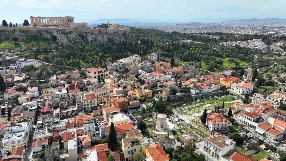 Aerial drone photo of iconic Acropolis hill and the Parthenon as seen from picturesque Plaka and Monastiraki districts - Roman forum, Athens historic centre, Attica, Greece