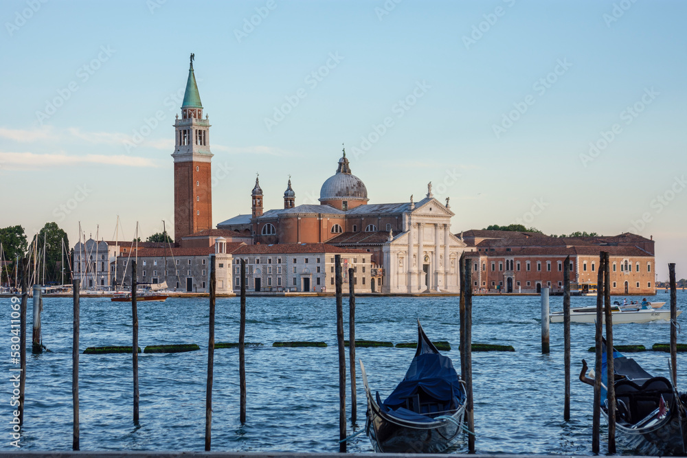 Piles and gondolas on the Venice canal, Church of San Giorgio Maggiore in the background
