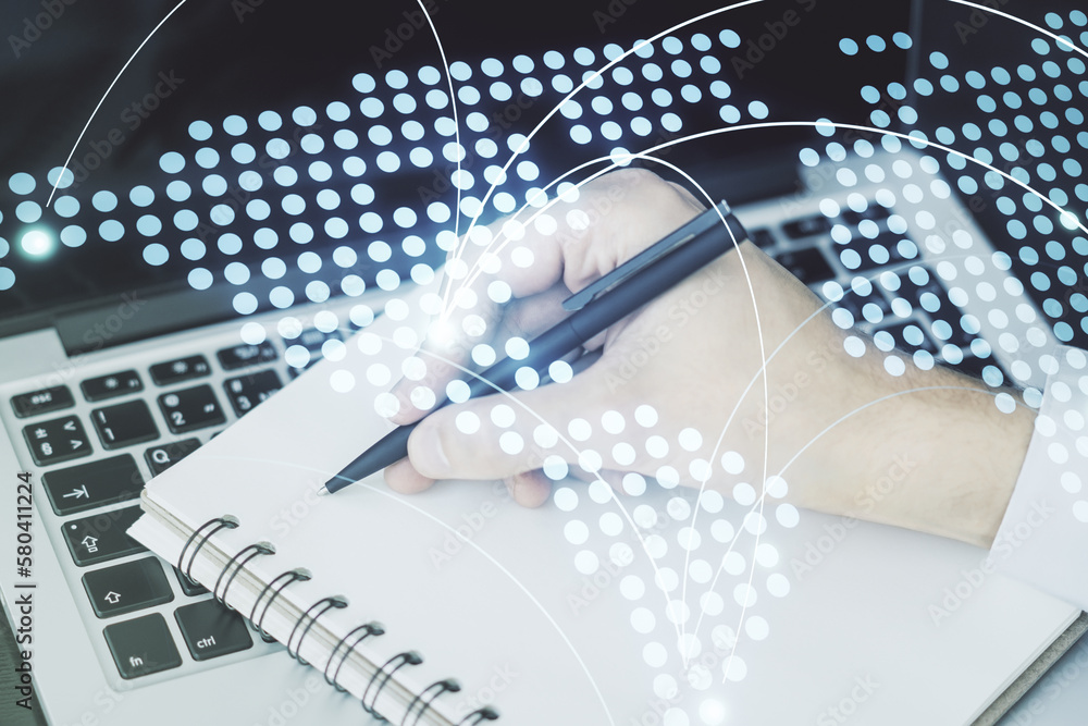Abstract creative world map with connections and hand writing in notebook on background with laptop, international trading concept. Multiexposure Abstract creative world map with connections and hand writing in notebook on background with laptop, international trading concept. Multiexposure
