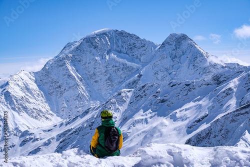 snowboarder looks at beautiful mountains