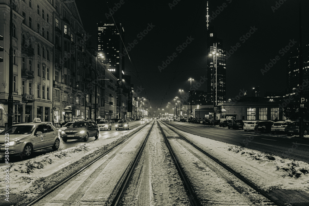 street at night in Warsaw with warm color and snow