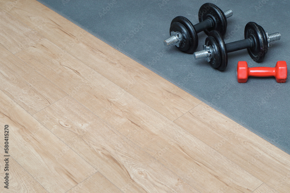 Fitness concept. Sport mat, dumpbells. Workout in home gym Fitness concept. Sport mat, dumpbells. Workout in home gym