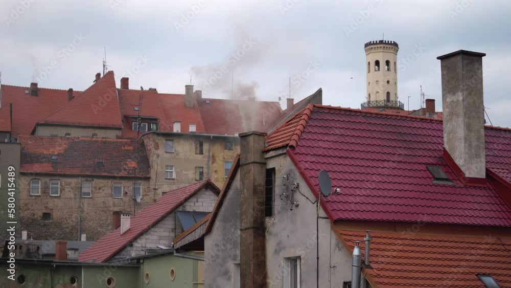 Old bricks buildings houses with smoky chimneys and red roofs in the city. Old bricks buildings houses with smoky chimneys and red roofs in the city.