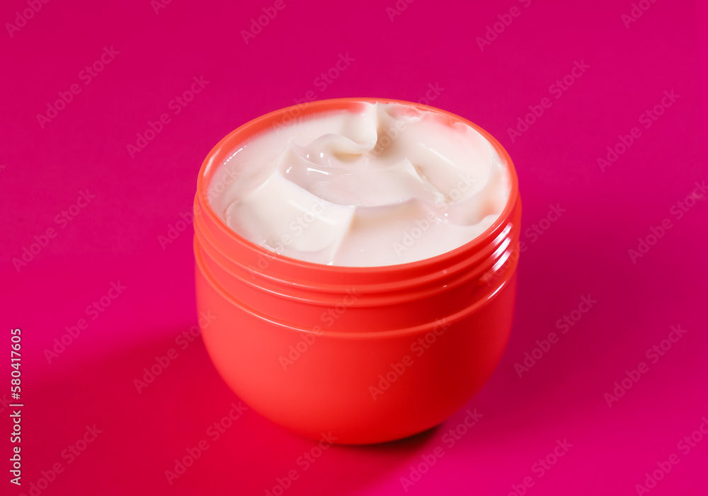 Delicate hand cream in a red container. Close-up of anti-aging cream Delicate hand cream in a red container. Close-up of anti-aging cream