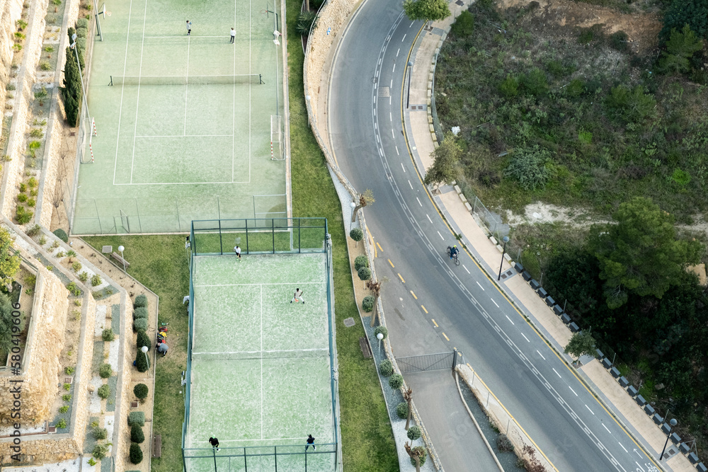 People playing in tennis padel and basketball court. Sports ground. Aerial view