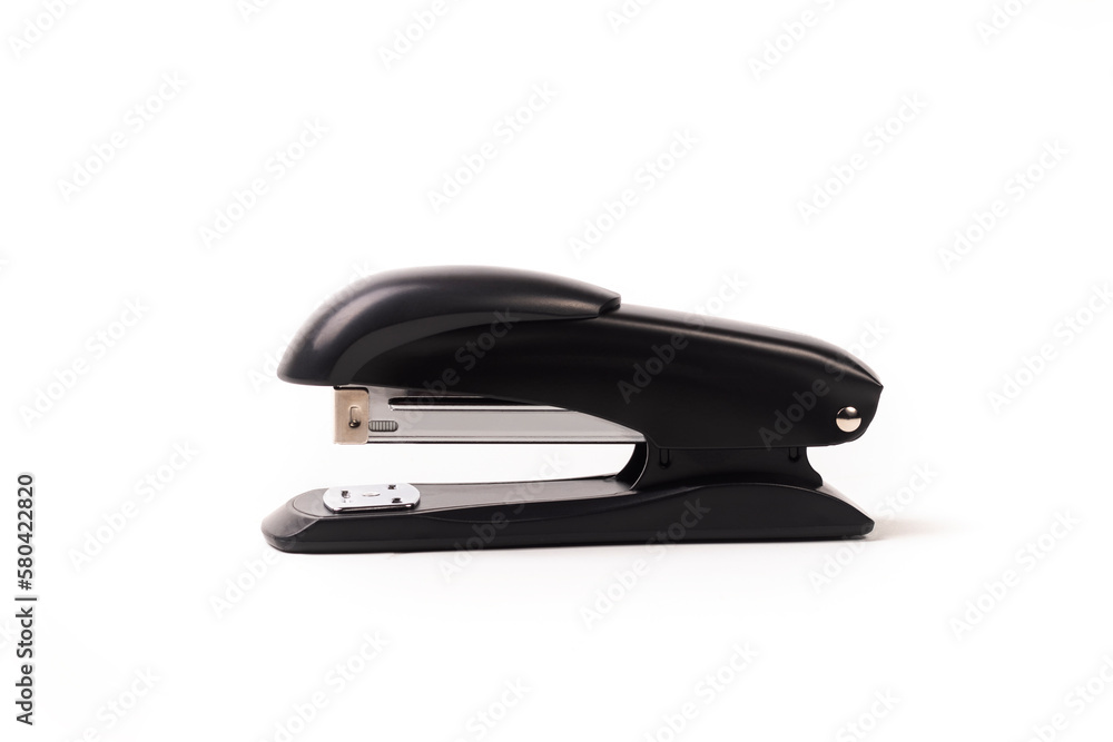 a dark metal stapler. close-up. on a white background. a dark metal stapler. close-up. on a white background.