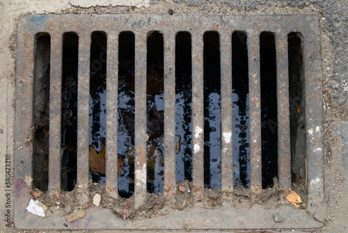 Dirty rectangular sewer or drain that installed in a street to collect rainwater