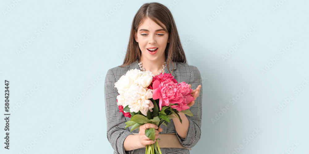 Surprised woman with beautiful peony flowers on light background Surprised woman with beautiful peony flowers on light background