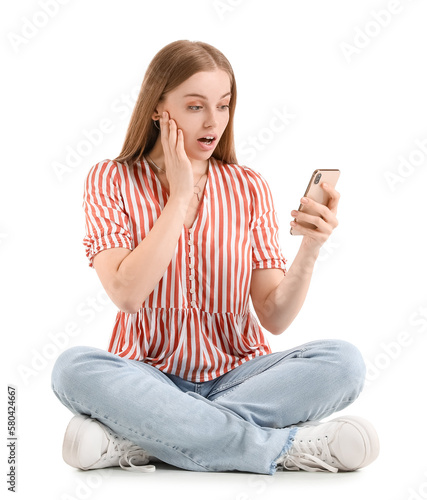 Surprised young woman using...
