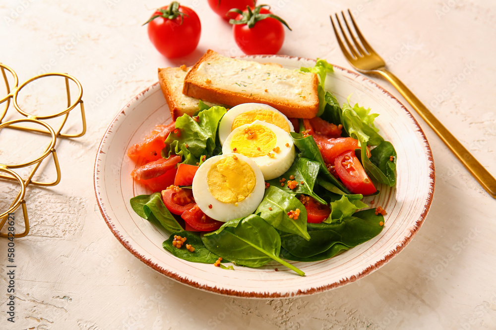 Plate of delicious salad with boiled eggs and salmon on white grunge background Plate of delicious salad with boiled eggs and salmon on white grunge background