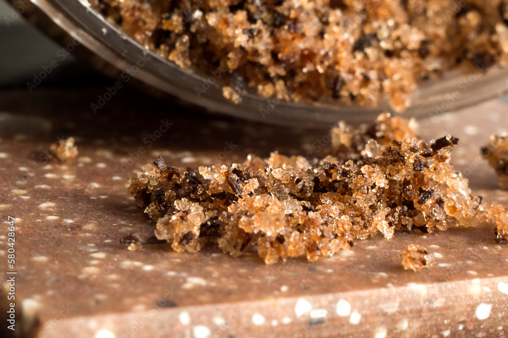 body scrub with sea salt, scattered on a dark surface body scrub with sea salt, scattered on a dark surface