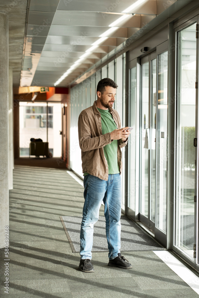 Young handsome man using mobile phone, shopping online, communication, watching video Young handsome man using mobile phone, shopping online, communication, watching video