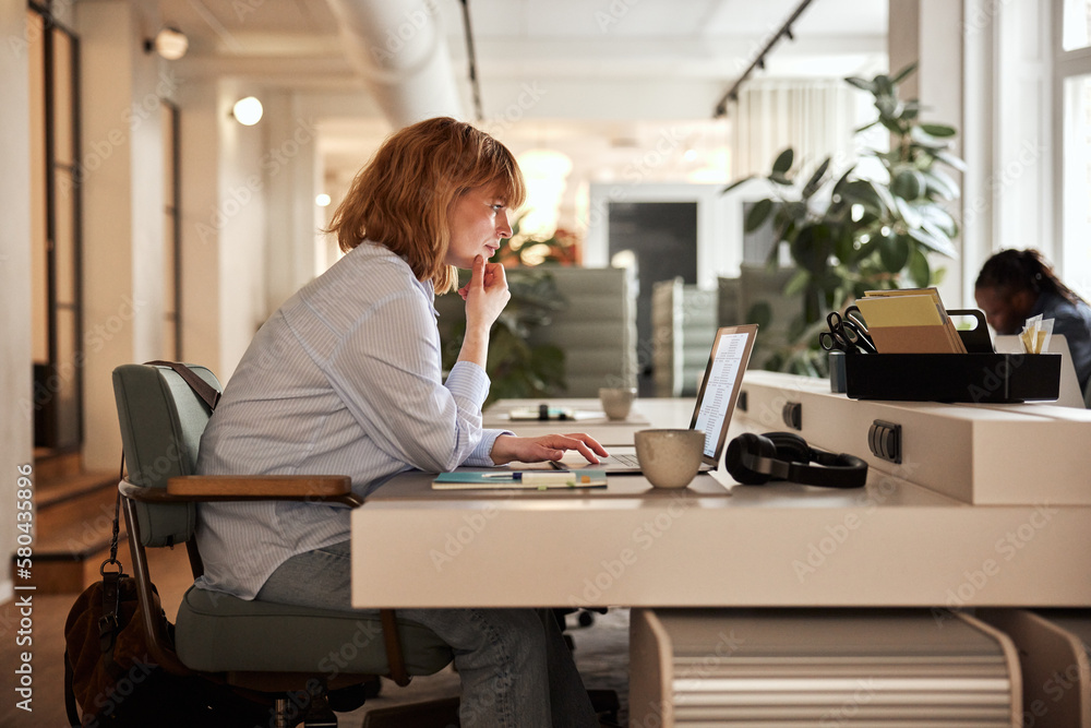 Businesswoman working online at her desk Businesswoman working online at her desk