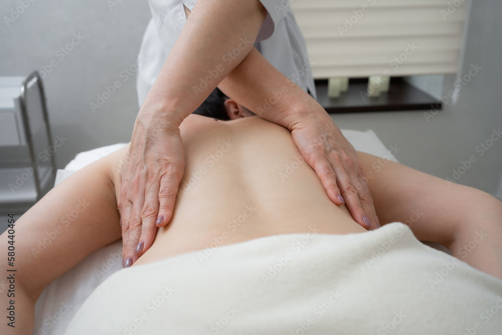 Fototapeta premium masseur doing back massage to woman