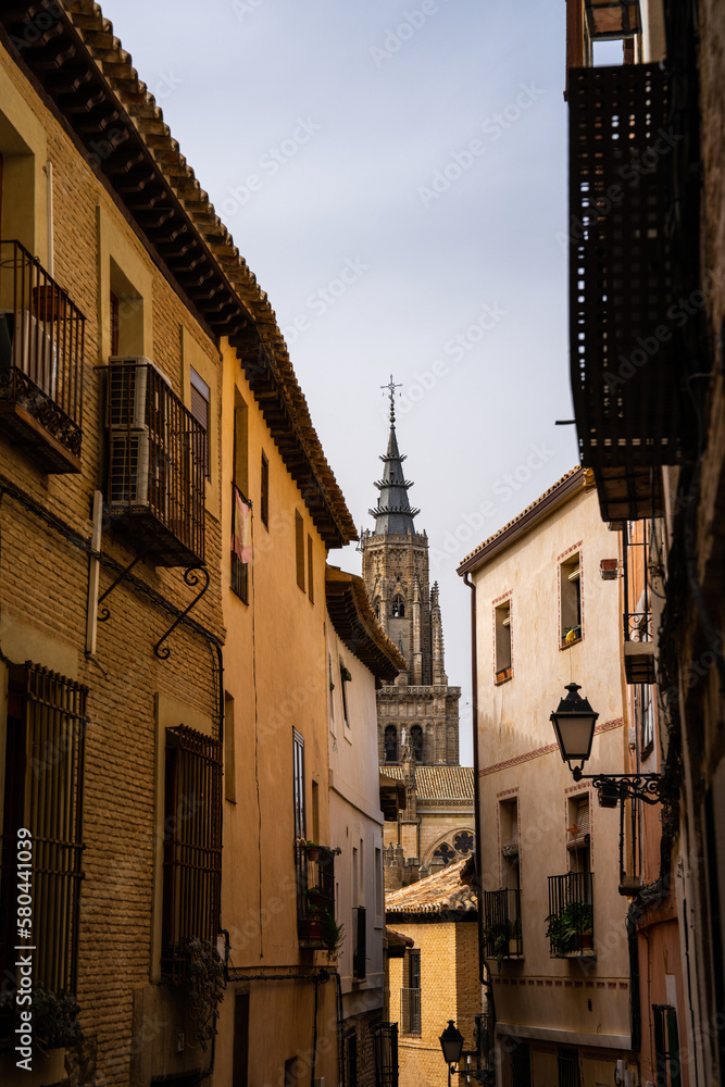View of Cathedral spire down an alley in Segovia Spain