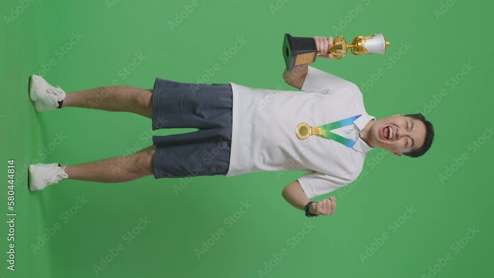 Full Body Of Asian Man With A Gold Medal And Trophy Screaming Goal ...