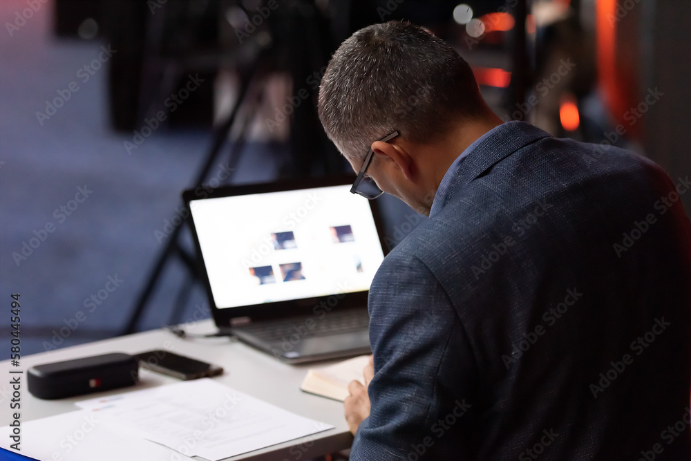 Fototapeta premium Selective focus of businessman in formal wear holding laptop during conference