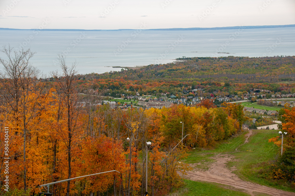 Blue mountain ski hill runs with the town of Collingwood and Georgian Bay in the background during autumn