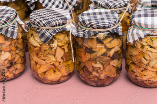 Glass jars with different types of canned mushrooms