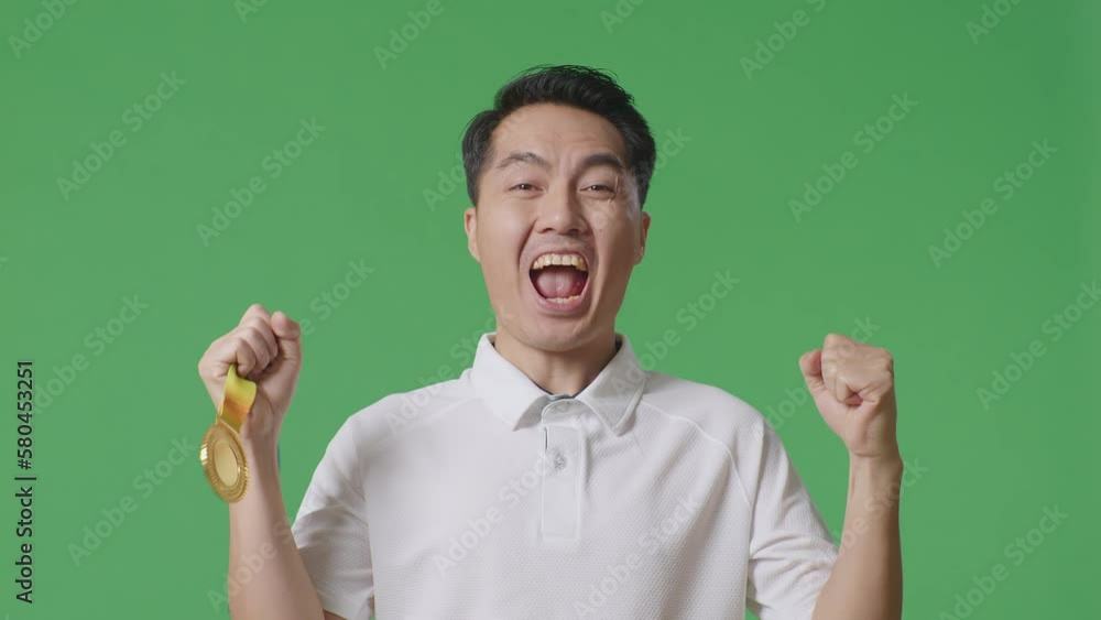 Close Up Of Asian Man Looking At A Gold Medal Then Screaming Goal Celebrating Winning As The First Winner On Green Screen Background In The Studio
Close Up Of Asian Man Looking At A Gold Medal Then Screaming Goal Celebrating Winning As The First Winner On Green Screen Background In The Studio