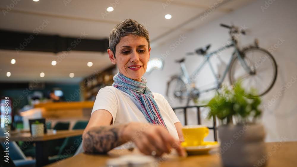 Fototapeta premium One woman senior caucasian female sit at cafe have a cup of coffee