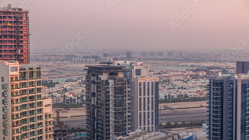 Luxury houses and villas near canal with towers aerial timelapse in Business Bay, Dubai, United Arab Emirates.