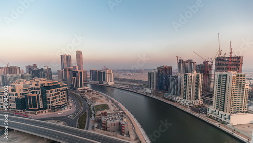 Skyscrapers at the Business Bay aerial evening timelapse in Dubai  United Arab Emirates