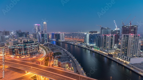 Skyscrapers at the Business Bay aerial day to night timelapse in Dubai  United Arab Emirates