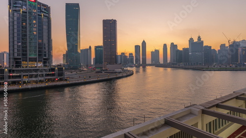 Modern city architecture in Business bay district. Panoramic view of Dubai s skyscrapers day to night timelapse