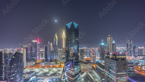 Panorama of futuristic skyscrapers in financial district business center in Dubai all night timelapse