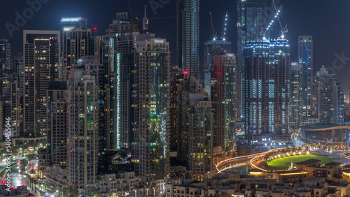Futuristic aerial all night cityscape timelapse with illuminated architecture of Dubai downtown  United Arab Emirates.