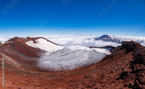 Vista en primer plano del crater del volvan lonquimay y  del volcán Tolhuaca entre las Nubes desde la cumbre del volcán Lonquimay, region de la Araucanía, Chile photo