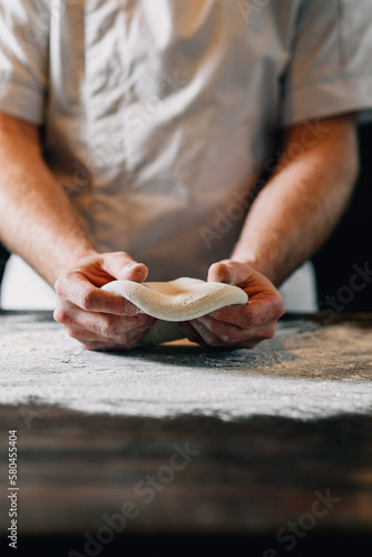 Man kneading pizza dough