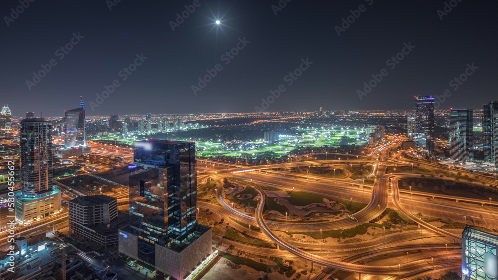 Fototapeta premium Panorama showing Dubai marina and JLT skyscrapers along Sheikh Zayed Road aerial night timelapse.