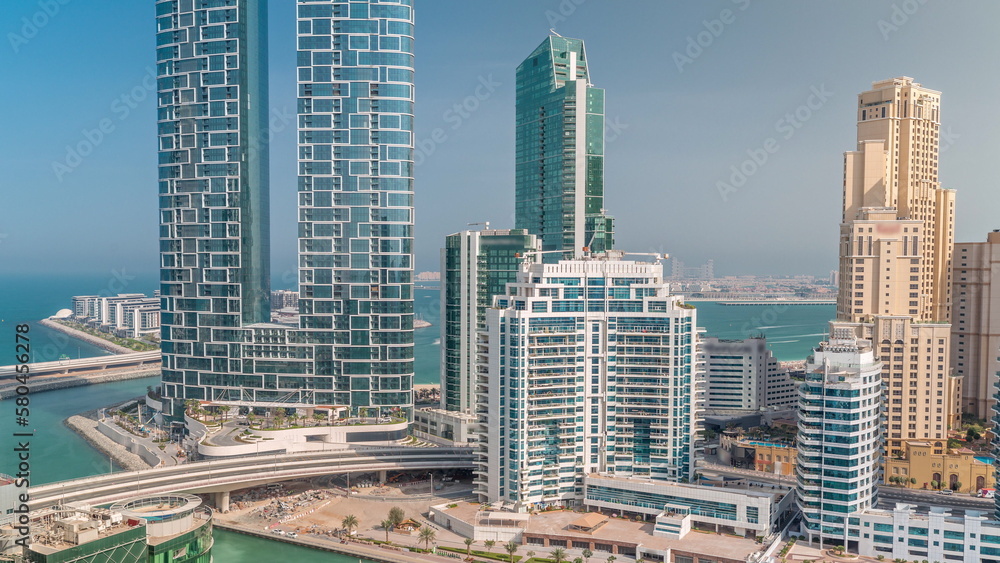 Promenade and canal seen from Dubai marina timelapse. Aerial view to JBR district and Bluewaters Island behind