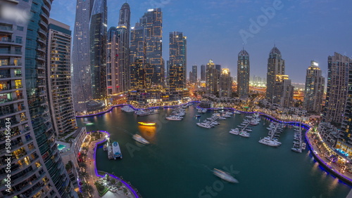 Dubai marina tallest skyscrapers and yachts in harbor aerial day to night timelapse. © neiezhmakov