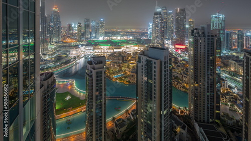 Dubai downtown with fountains and modern futuristic architecture aerial all night timelapse