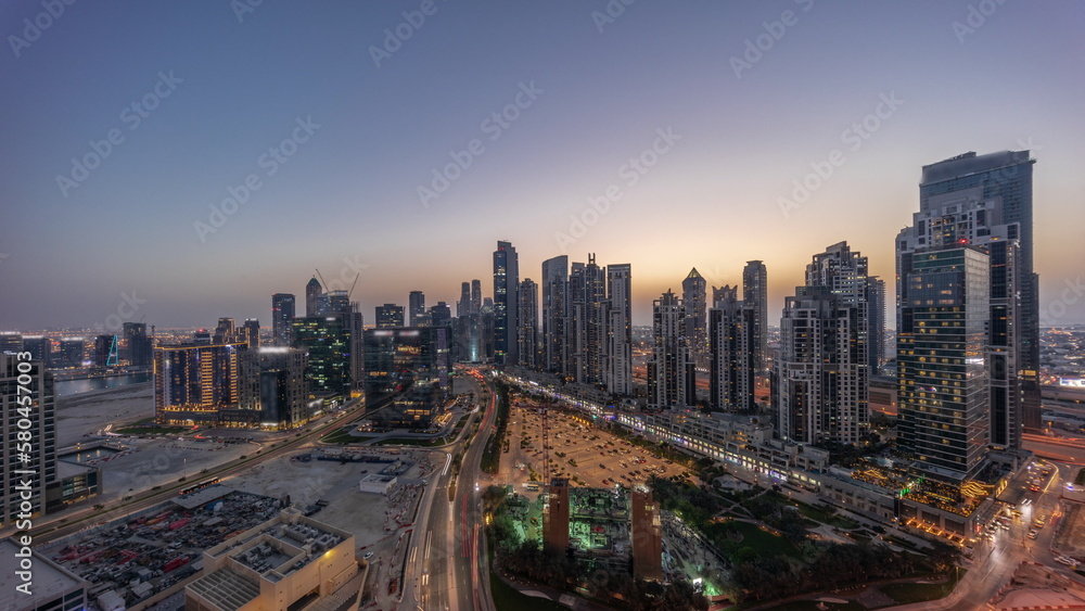 Panorama of Bay Avenue with modern towers residential development in Business Bay aerial day to night timelapse, Dubai