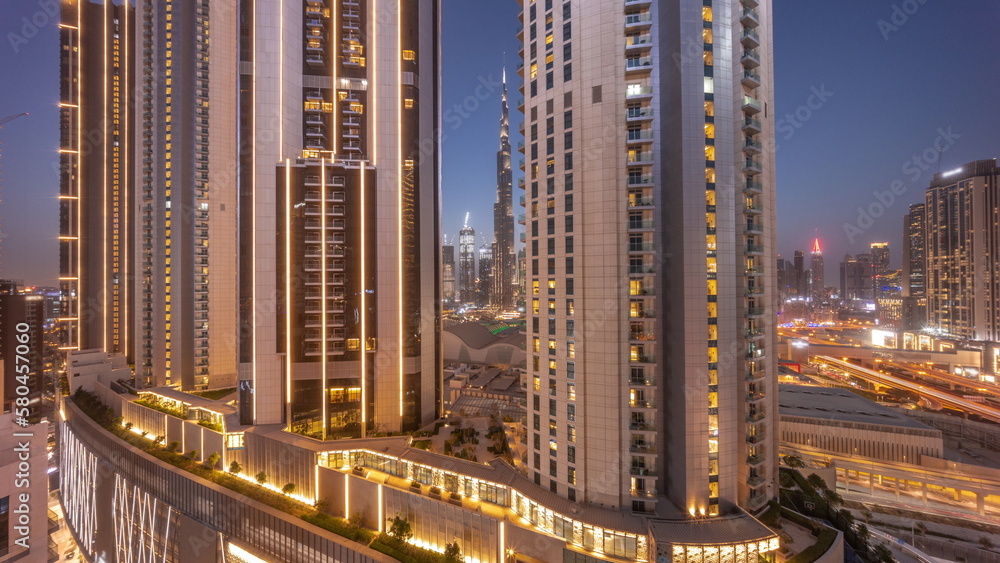 Obraz premium Tallest skyscrapers in downtown dubai located on bouleward street near shopping mall aerial day to night timelapse.