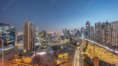 Business Bay with modern towers residential development aerial panoramic day to night timelapse, Dubai