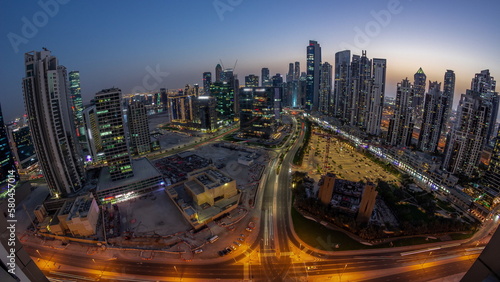 Panoramic skyline of Bay Avenue with modern towers residential development in Business Bay aerial day to night timelapse  Dubai