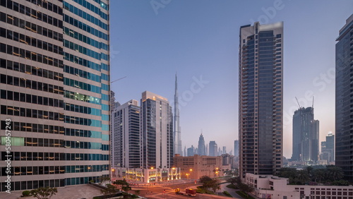 Aerial panoramic view to Dubai downtown and difc skyscrapers night to day timelapse.