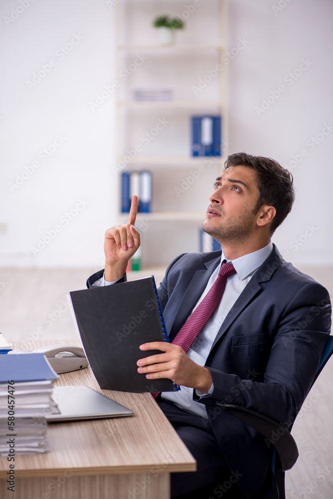 Young male employee working in the office Young male employee working in the office