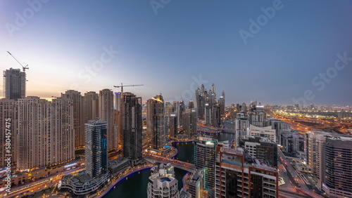 View of various skyscrapers in tallest recidential block in Dubai Marina aerial day to night timelapse © neiezhmakov