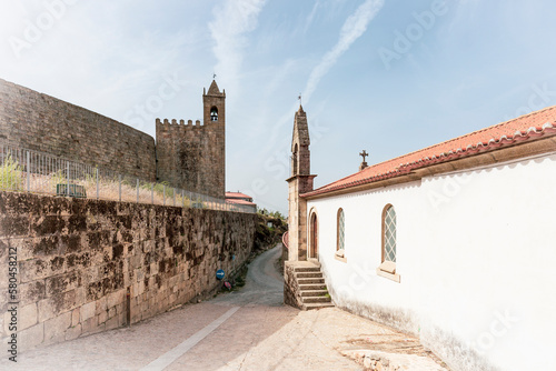 clock tower on the castle wall and the Church of Mercy in Penamacor, district of Castelo Branco, Beira Baixa, Portugal - October 2022 photo