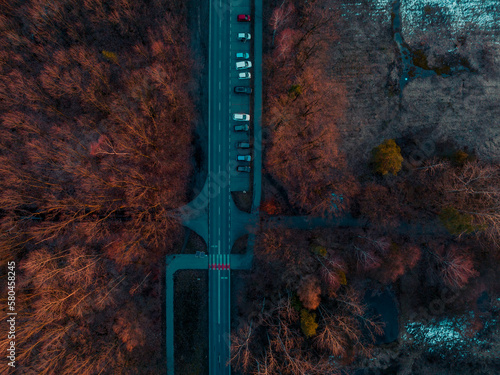 Aerial view, drone on a parking lot in the forest. The concept of rest, leaving the car in the parking lot and spending time in the forest, outdoors.