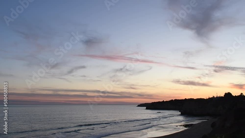 Video of sunset at the Atlantic Ocean in Armacao de Pera. 4K video of beach in the Algarve, Portugal.