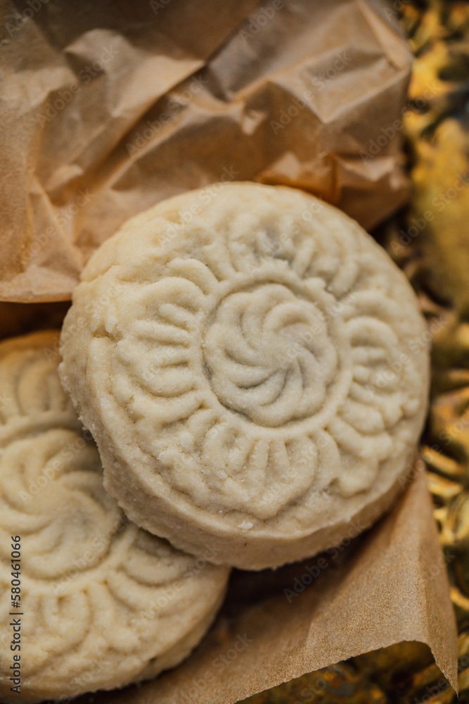 close up of maamoul (ma'amoul), date-filled butter cookies with a decorative pattern. Ma'amoul is a popular dessert throughout the Middle East for holidays such as Easter or Eid. close up of maamoul (ma'amoul), date-filled butter cookies with a decorative pattern. Ma'amoul is a popular dessert throughout the Middle East for holidays such as Easter or Eid.